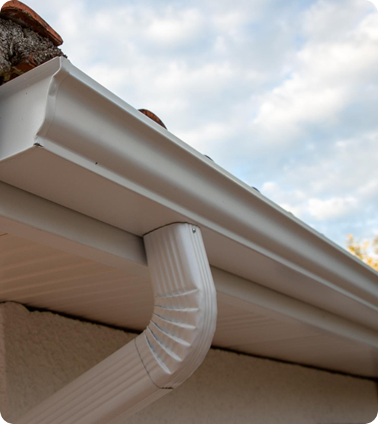 completed beige gutter replacement on a residential roof