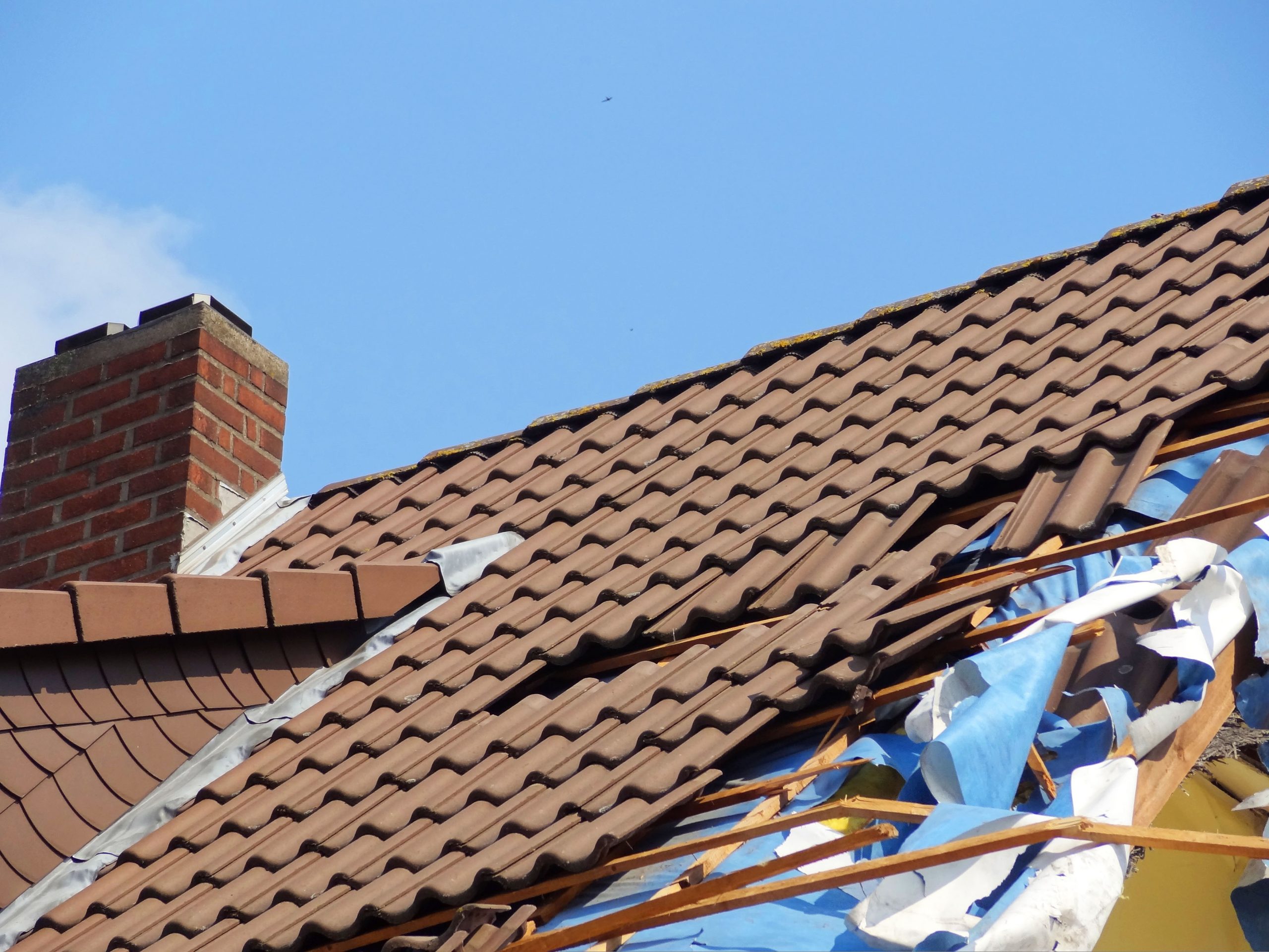 damage to a residential roof from strong wind